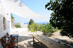 One of three houses at a private field, fifty steps above the center of Mandraki Cholargos, Greece Stone house with sea view Earthen home vacation rental 26422943