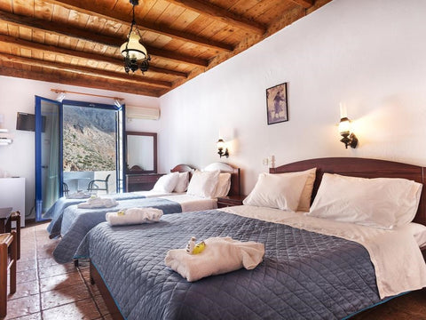 All rooms are sea view with balcony and offer air conditioning, 43" flat TV and  Loutro, Greece Quad with Sea View Room in hotel vacation rental 30224834