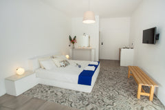 Accommodation situated in Kamari, 20 meters from its volcanic black beach. Tradi Kamari, Greece bed & breakfast by the sea Private room in bed and breakfast vacation rental 11488409