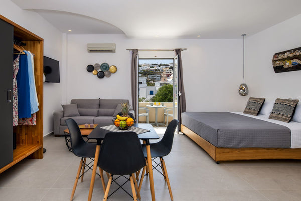 This suite features a bedroom with a white built-in bed, a modern hand-crafted b Greece Queen Suite with Spa Bath by Alizea Villas Private room in bed and breakfast vacation rental 35929767