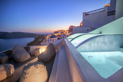 Spacious suite consisting of a bedroom with en-suite bathroom, and an open-plan   Theodora Suites - Cave Suite with Volcano View Room in aparthotel vacation rental 40462018