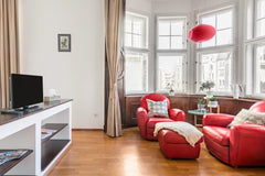 Rest up in scarlet leather armchairs after exploring the scenic streets in the h Prague, Czechia Overlook Rooftops from the Bay Window in the Jewish Quarter Entire rental unit vacation rental 23036890