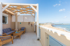 Relax on the spacious balcony overlooking the crashing waves at a bright, stylis Rethimnon, Greece Nathalie's Beachfront Apartment Entire rental unit vacation rental 47284202
