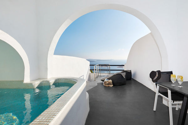 Features balcony overlooking the volcano, the sunset, the caldera and the Aegean  Honeymoon Suite with outdoor heated private Jacuzzi Room in hotel vacation rental 39737571